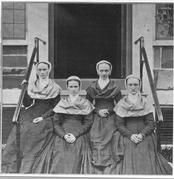 SA0164 - Four Shaker sisters on the steps of a building. Identified on the back as young Shakers sisters from New Lebanon., Winterthur Shaker Photograph and Post Card Collection 1851 to 1921c